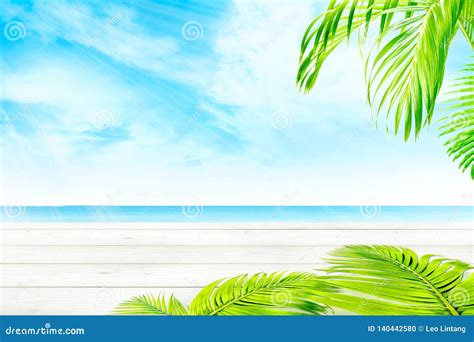 Wooden Table And Green Palm Branches With Blue Ocean View Stock Photo