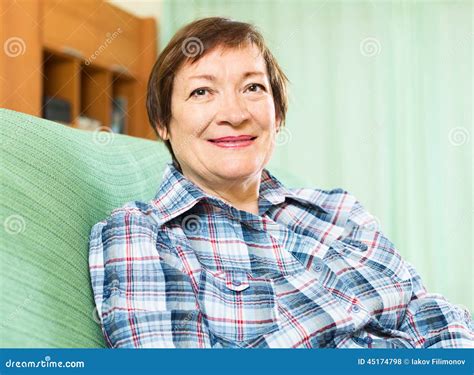 Portrait Of Happy Senior Woman Relaxing In Couch Stock Photo Image Of