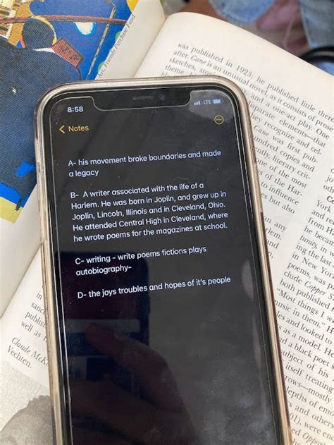 An Open Book With Text On It And A Cell Phone In Front Of The Book