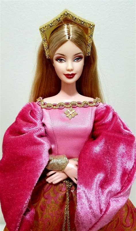 A Barbie Doll Wearing A Pink Dress And Gold Tiara With Red Hair