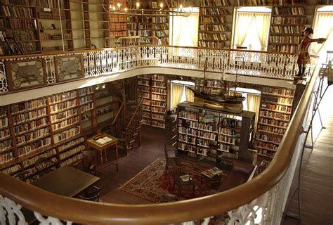 The Inside Of A Library With Many Bookshelves