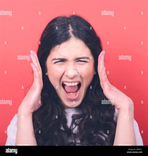 Portrait Of Angry Girl Screaming Against Red Background Stock Photo Alamy