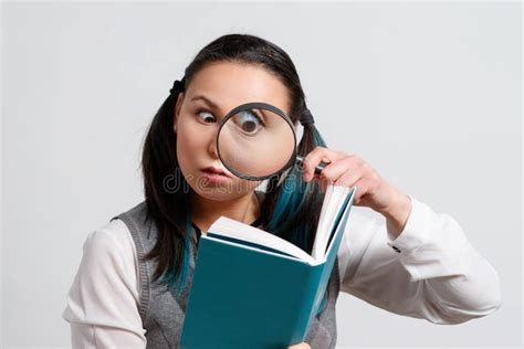 Portrait Of A Funny Young Woman Looking At The Camera Through