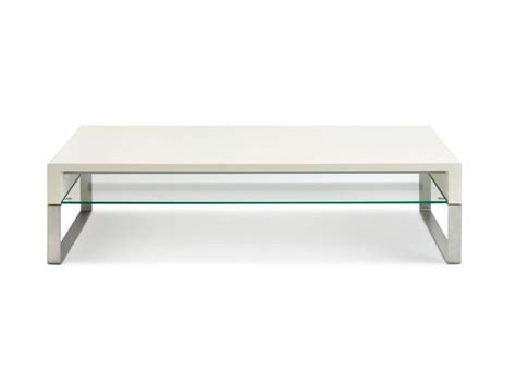 A White Coffee Table With Glass Top And Metal Legs