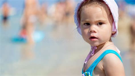 Child Girl Is Playing On Sandy Beach Near Blue Sea Stock Image Image