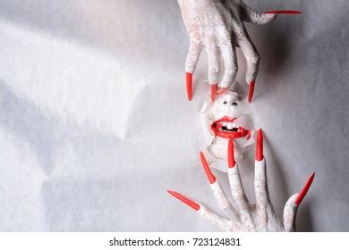 Horrifying Vampire Tearing Hole Through Paper Stock Photo