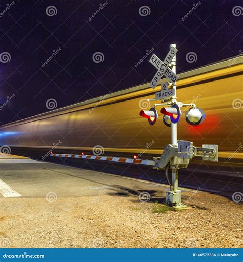 Railroad Crossing With Passing Train By Night Stock Photo Image Of