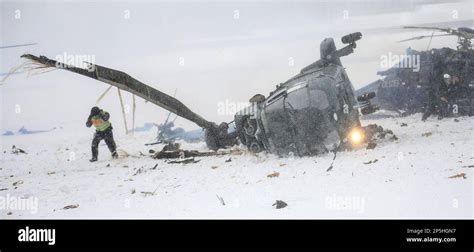 Rescue Workers Examine Two Crashed Helicopters Of The German Federal