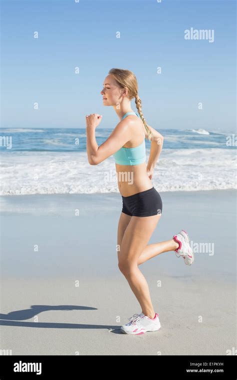 Fit Blonde Jogging On The Beach Stock Photo Alamy