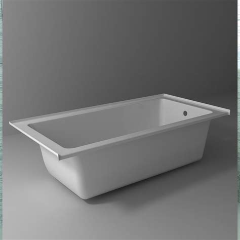 a white bathtub sitting on top of a gray floor next to a wall with grey ...