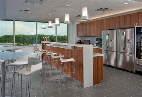 a large kitchen with stainless steel appliances and wooden cabinets