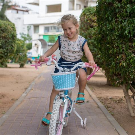 Premium Photo Smiling Girl Riding Bicycle At Public Park