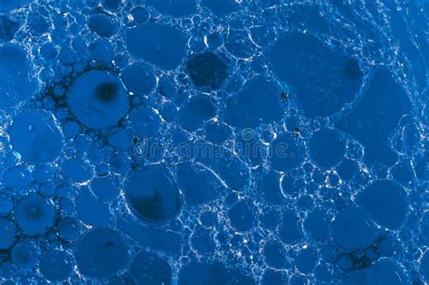 Closeup Of Blue Translucent Soap Bubbles Floating On The Water Surface