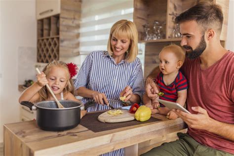 Parents And Children Cooking Dinner In The Kitchen Stock Image Image