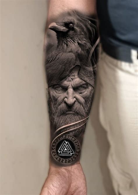 A Man S Arm With An Image Of A Crow And A Raven On It