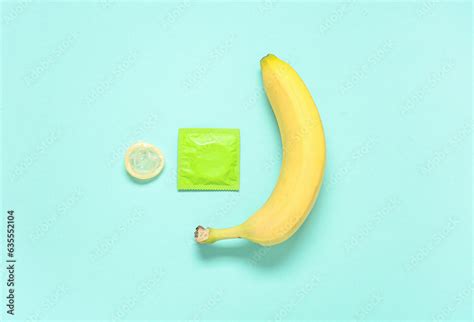 Fresh Banana And Condoms On Turquoise Background Sex Education Concept