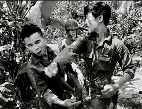 A South Vietnamese Soldier Punches A Captured Viet Cong Guerrilla