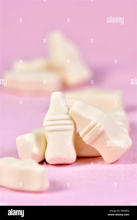 Milk bottle sweets on pink background Stock Photo - Alamy