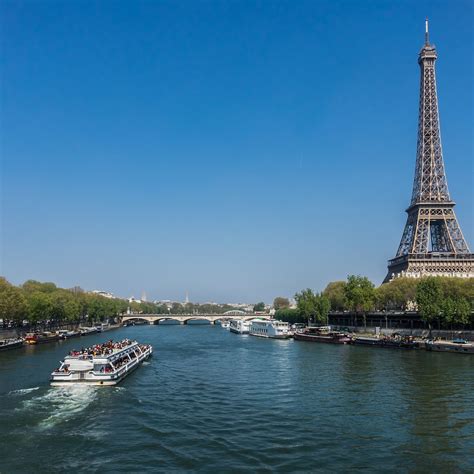 The Eiffel Tower Towering Over The City Of Paris From Across The River