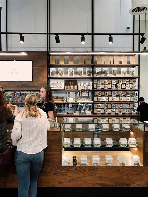 Two Women Are Standing In Front Of The Counter At A Cosmetics Store