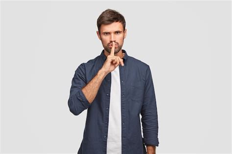 Free Photo Photo Of Serious Male Keeps Index Finger On Lips As