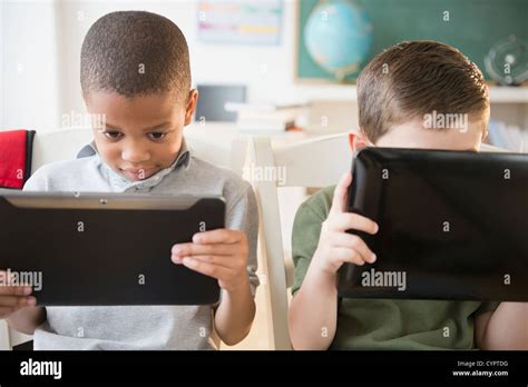 Students using digital tablets in classroom Stock Photo - Alamy