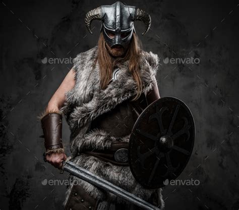 Fierce viking from past with shield and sword Stock Photo by fxquadro