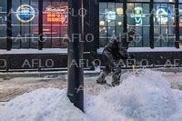 A Man Shovels Snow Off The Sidewalk In Ankeny Iowa On January