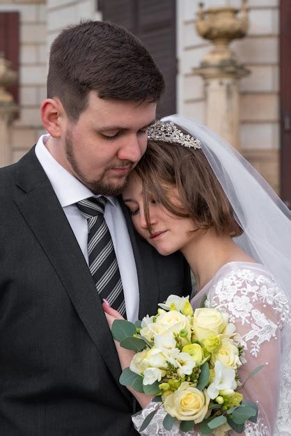 Premium Photo Wedding Portrait The Groom Hugs The Bride She Clung To