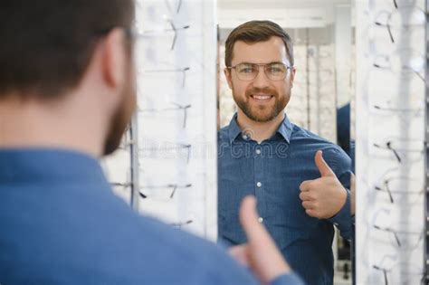 Satisfied Customer View Of Happy Young Male Client Wearing New Glasses