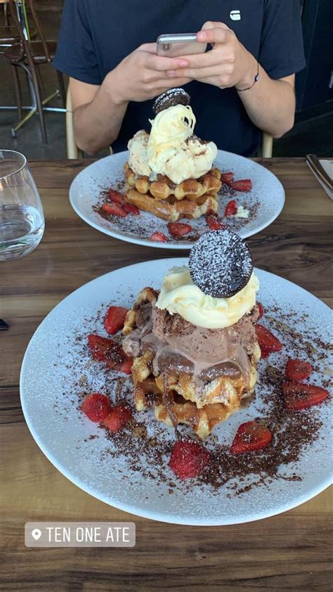 Two White Plates Topped With Waffles Covered In Chocolate And