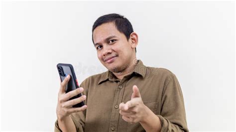 Confident And Serious Face Expression Of Young Asian Malay Man Pointing