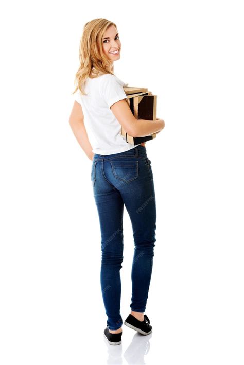 Premium Photo Smiling Young Woman Holding Books Against White Background