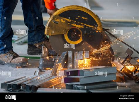 Construction Worker Cutting Galvanized Steel Metal Framing Studs For