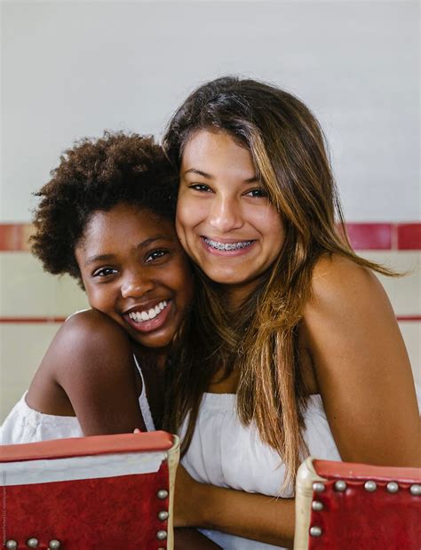 Beautiful Hispanic Girl With Braces And African American Sister By Stocksy Contributor