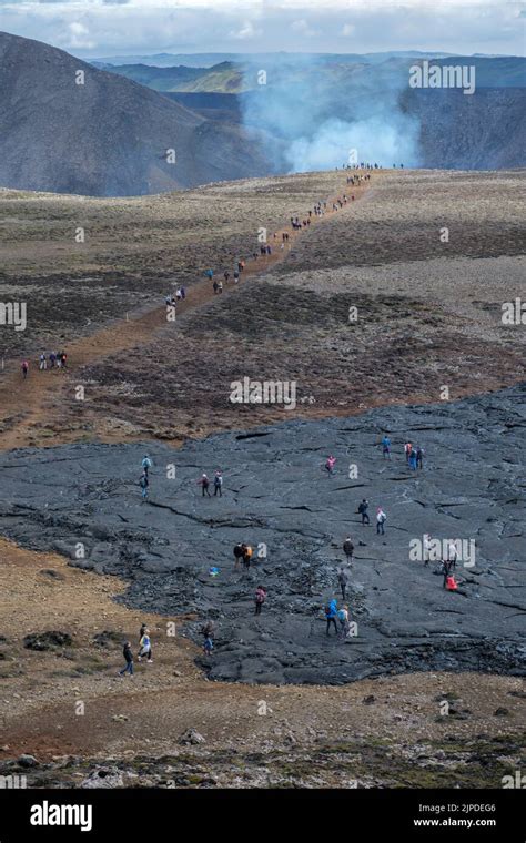 Hikers Passing The Old Lava Field On The Way To The Eruption Of The