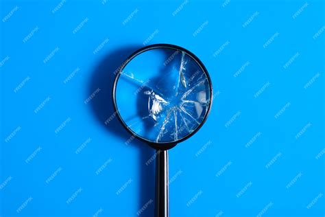 Premium Photo Broken Magnifying Glass With Cracks On Blue Background Top View