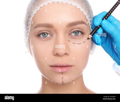 Doctor Marking Young Woman Face Before Cosmetic Surgery On White