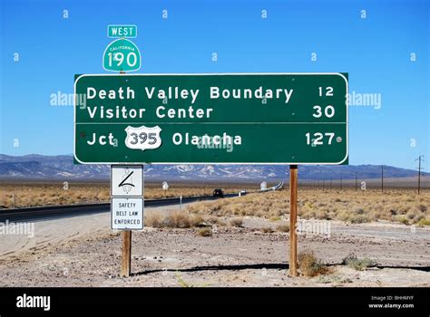 Highway Sign With Mileage Distance To Death Valley Visitors Center And