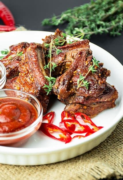 Premium Photo Baked Ribs Roasted Pork Ribs With Spices And Herbs On A