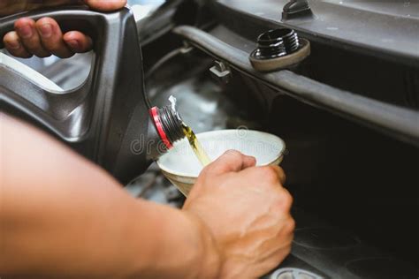 Mechanic Pouring Oil To Vehicle Engine Serviceman Changing Motor Oil