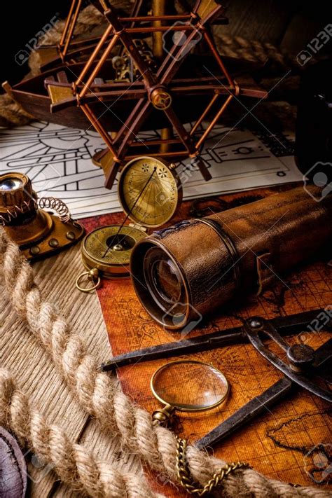 An Old Map Compass Magnifying Glass And Other Items On A Table