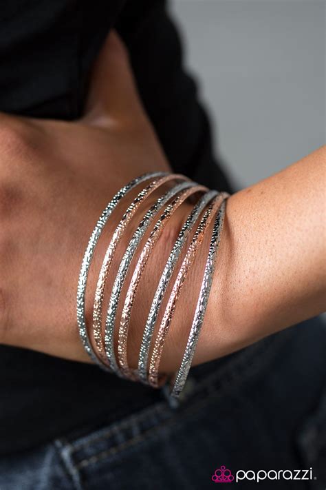 Stacked Machine- multi Embossed in stunning textures, three copper bangles and four silver ...