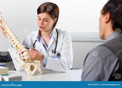 Orthopaedic Surgeon Studying A X Ray Of A Broken Radius Bone In Theatre