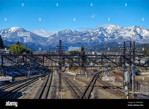 Nikko Train Station Rails With Snowy Japanese Alps In The Backgound