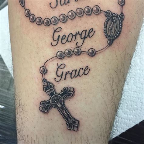 A Tattoo With The Words Faith George Grace And A Cross On It S Leg