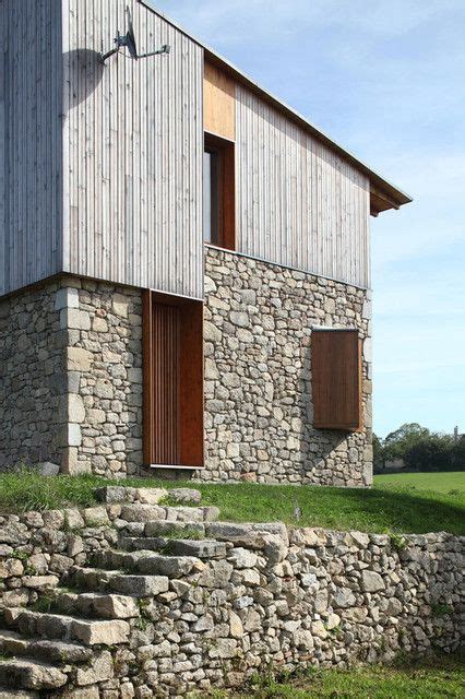 A Stone Wall And Steps Leading To A Building With Wooden Doors On The