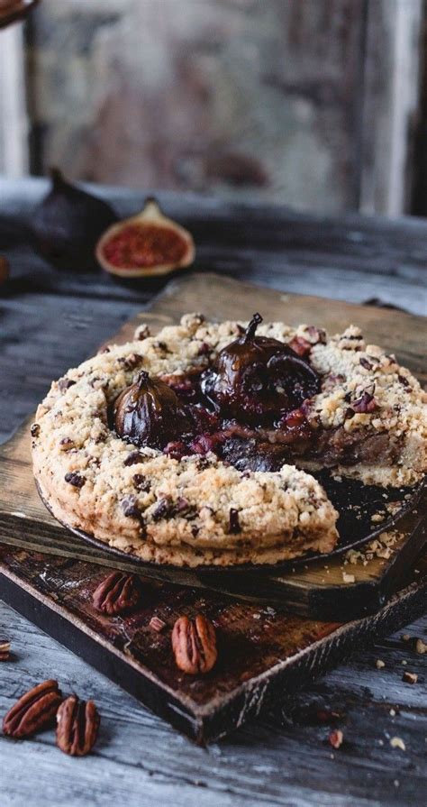 A Chocolate Chip Cookie With Pecans Around It On A Wooden Table Next To