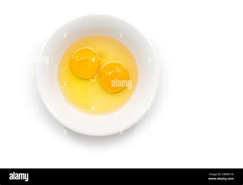 Isolated Raw Chicken Eggs Top View Of Two Raw Egg Yolk In White Bowl