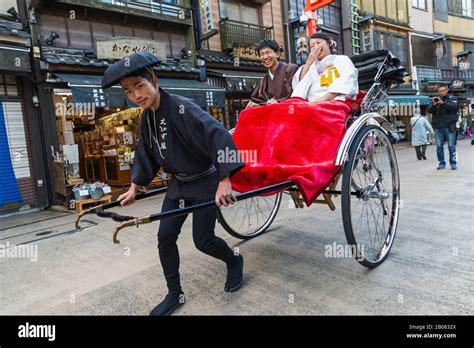 Japan Honshu Tokyo Asakusa Couple Riding In Rickshaw Stock Photo